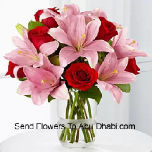 Red Roses And Pink Lilies With Seasonal Fillers In A Glass Vase